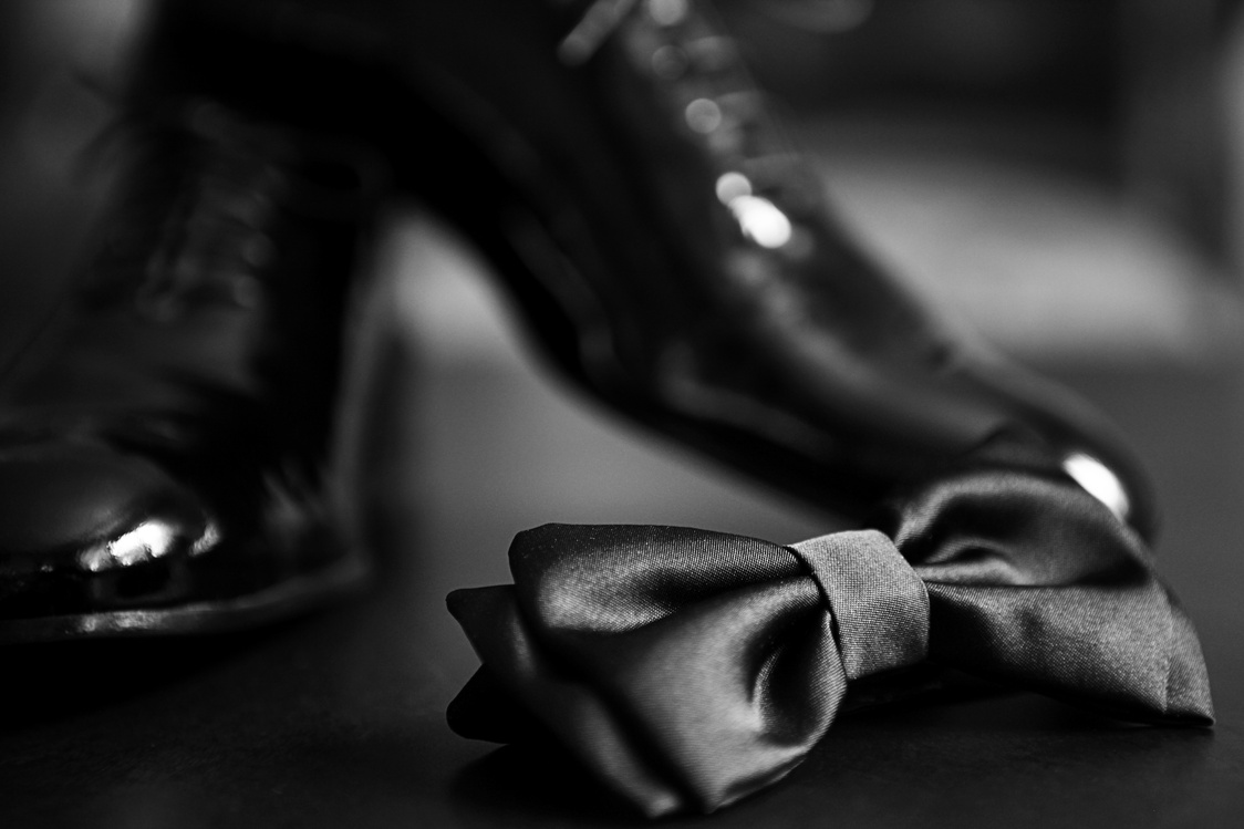 Black bow tie and black shiny shoes